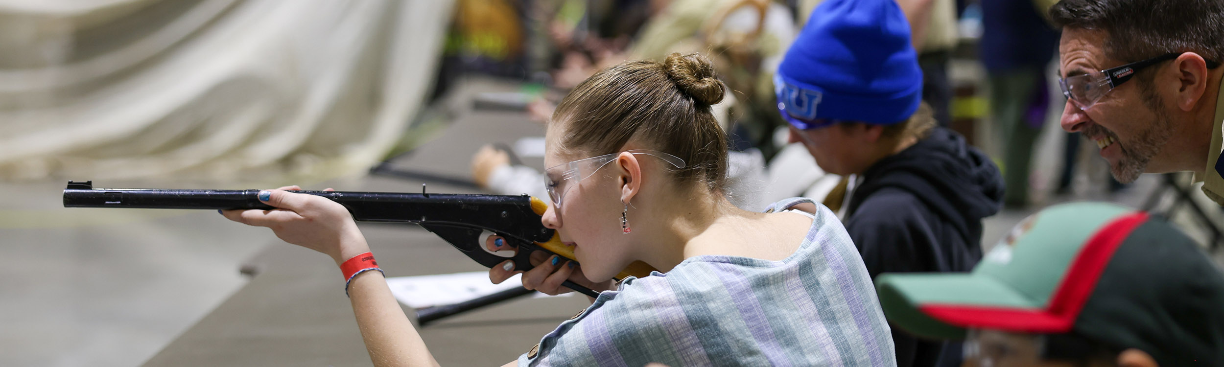 Youth learning how to shoot a gun